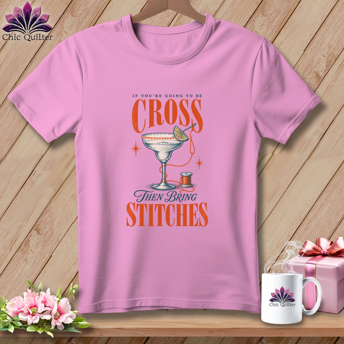 Pink t-shirt with "If you're going to be cross, then bring stitches" text and design.