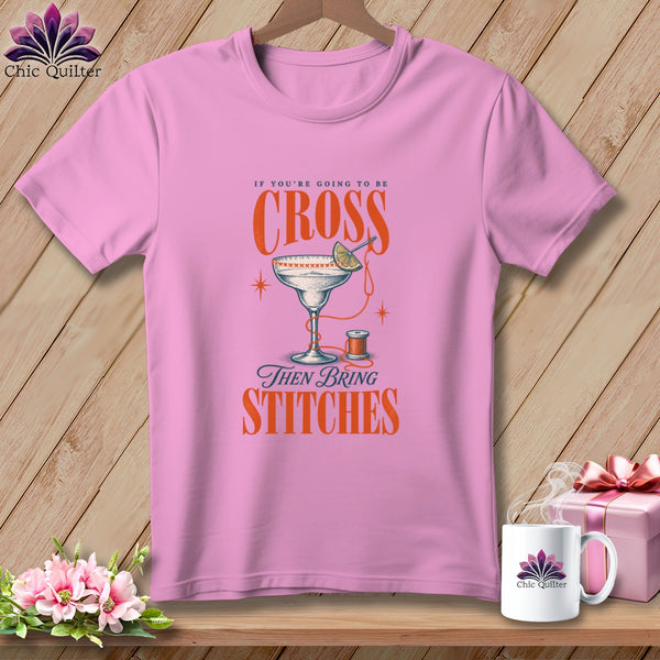 Pink t-shirt with "If you're going to be cross, then bring stitches" text and design.