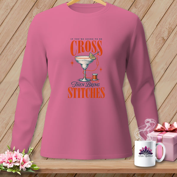 Pink long-sleeve shirt with "If You're Going to Be Cross Then Bring Stitches" graphic.