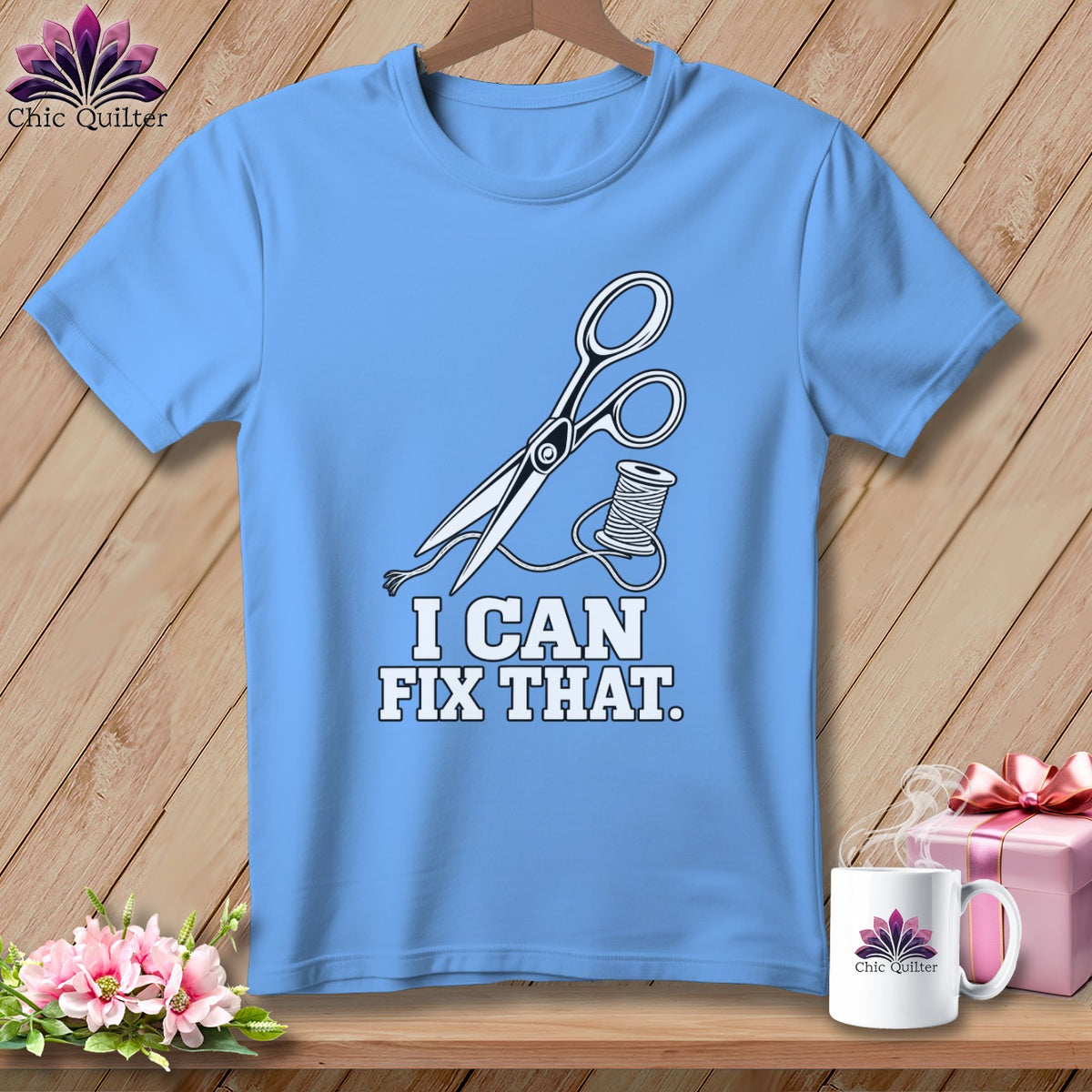 Light blue t-shirt with scissors, thread, and text "I CAN FIX THAT."