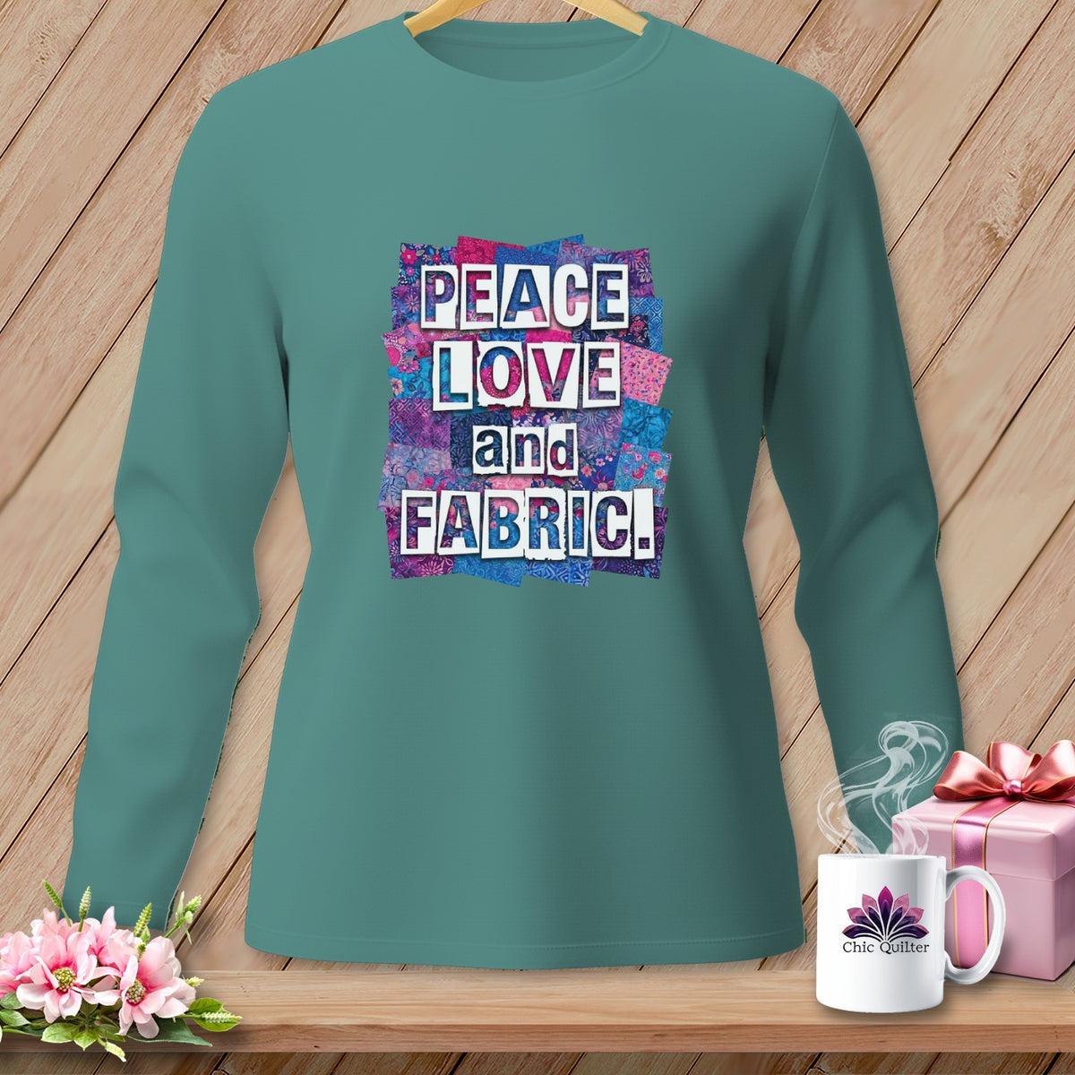 Teal long-sleeve shirt with "PEACE LOVE and FABRIC." text design.