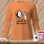 Orange long-sleeve shirt with a cartoon penguin at a sewing machine and the text "pedal to the metal".