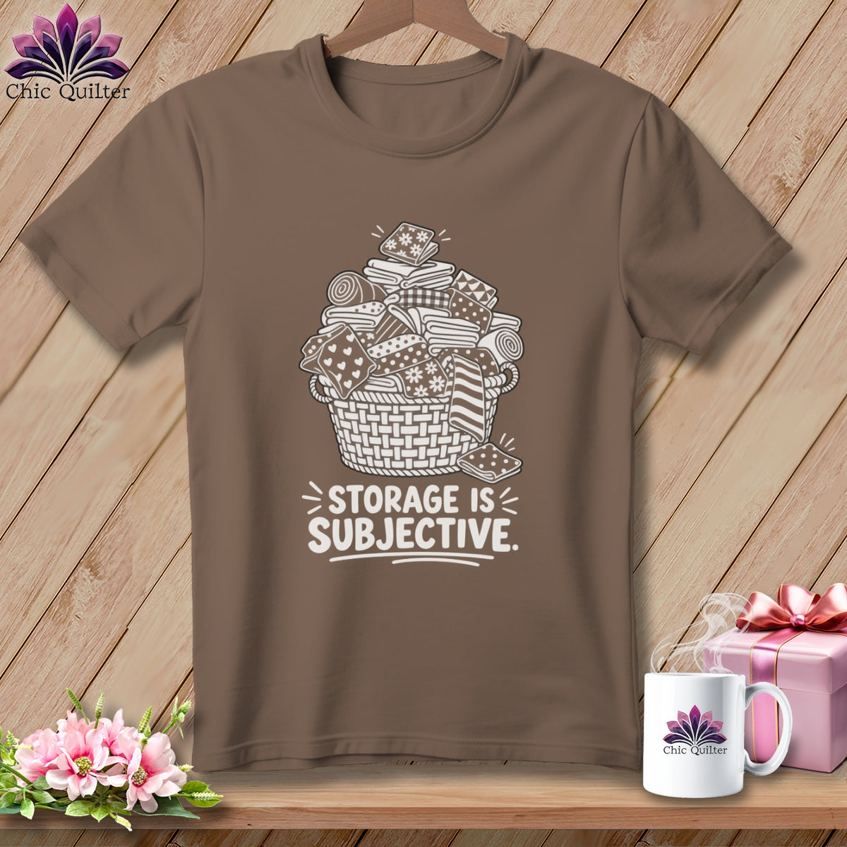 Brown t-shirt with white illustration of a basket overflowing with fabric scraps and the text "STORAGE IS SUBJECTIVE."