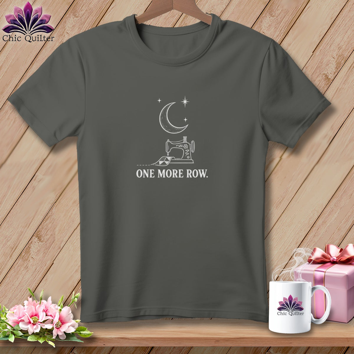 Dark grey t-shirt with sewing machine, moon, stars, and text "ONE MORE ROW".