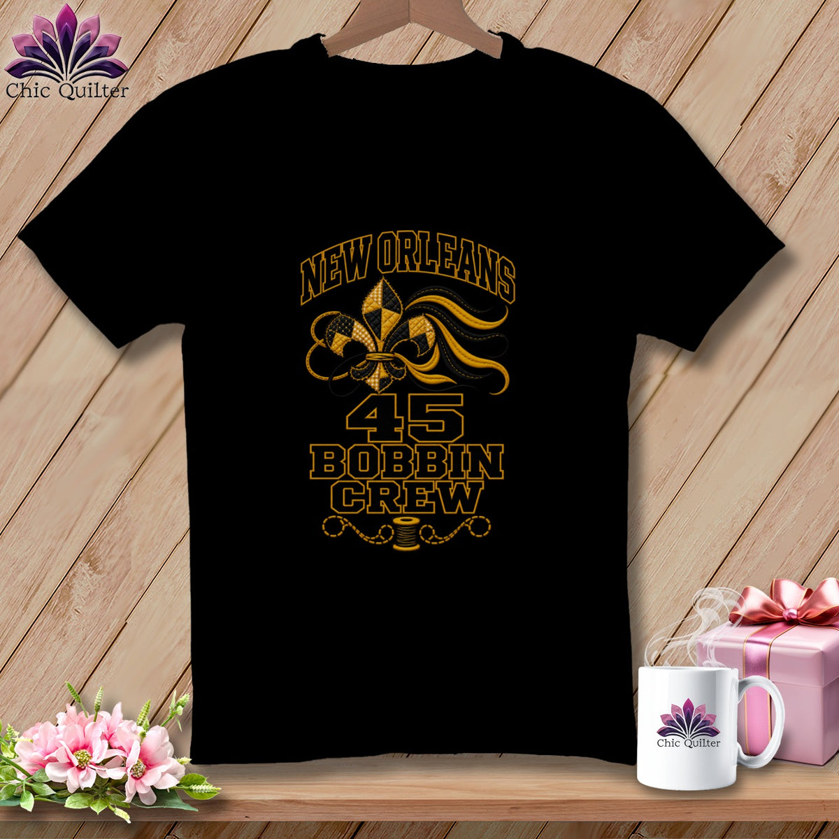 Black t-shirt featuring a New Orleans 45 Bobbin Crew design with a gold fleur-de-lis.