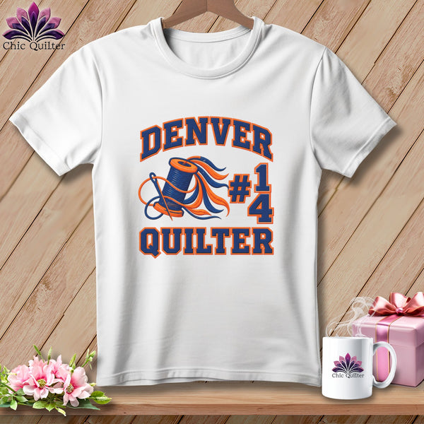 White t-shirt featuring a graphic of a thread spool, needle, and text reading Denver #1 Quilter.
