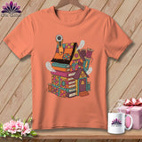 T-shirt with a whimsical house made of books, sewing notions, and cute ghosts.