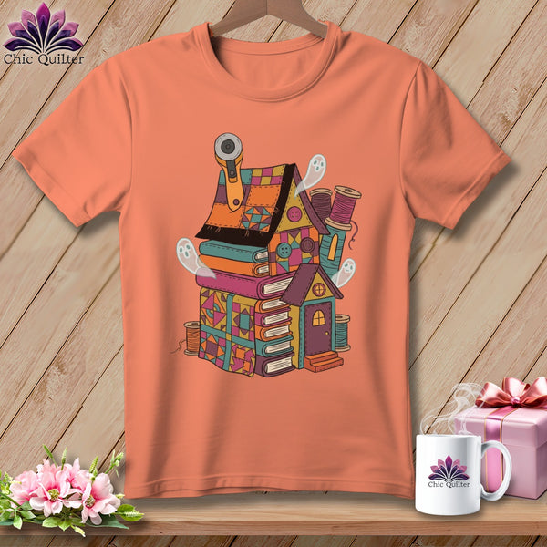 T-shirt with a whimsical house made of books, sewing notions, and cute ghosts.