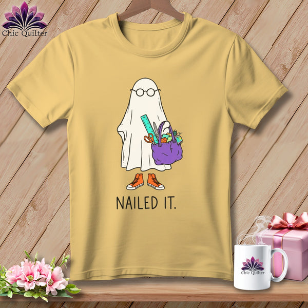 Yellow t-shirt with a cartoon ghost holding craft supplies and the text "NAILED IT."