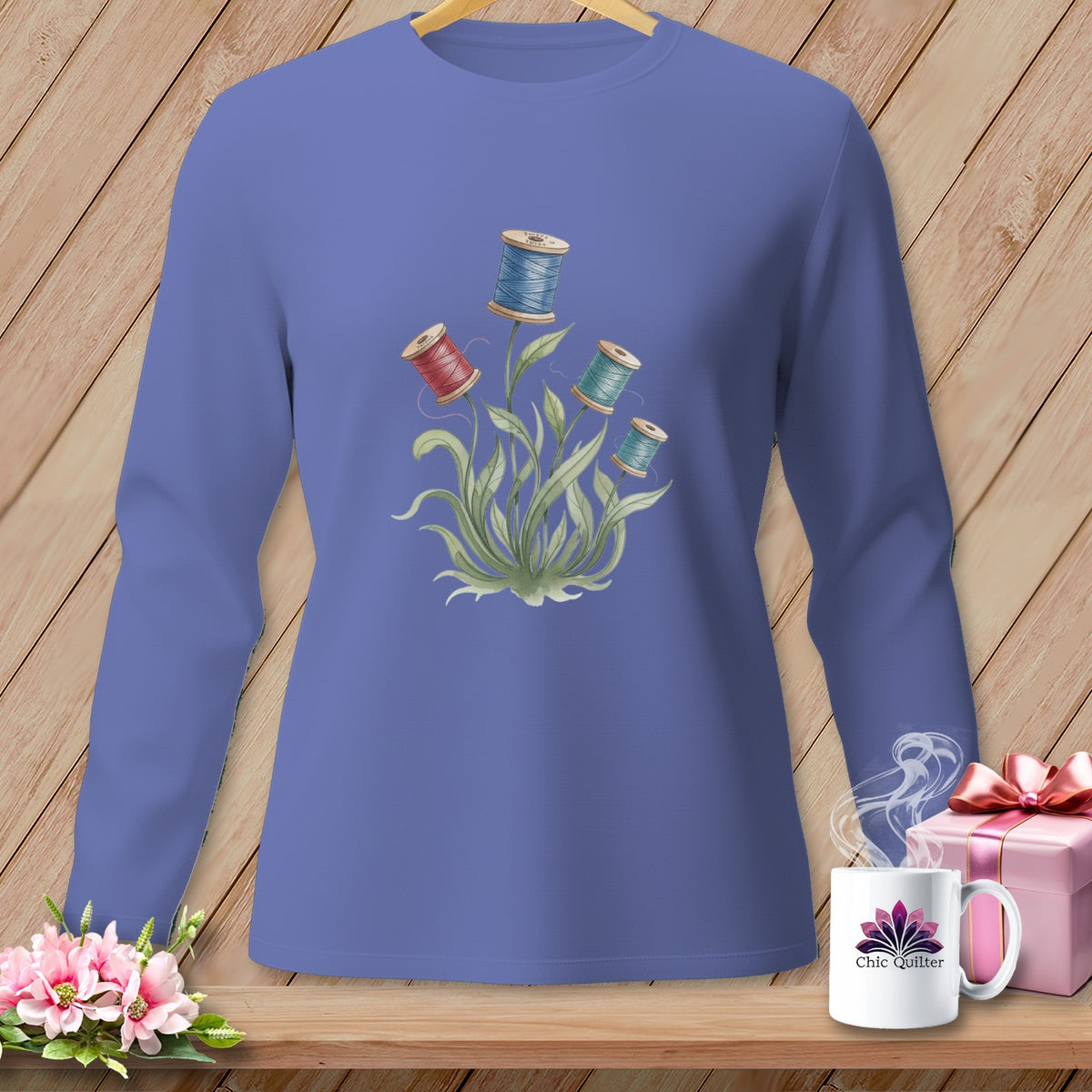 Purple long-sleeve shirt with spool of thread floral design.