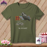 Olive t-shirt with a raven unraveling quilt squares and thread, reads 