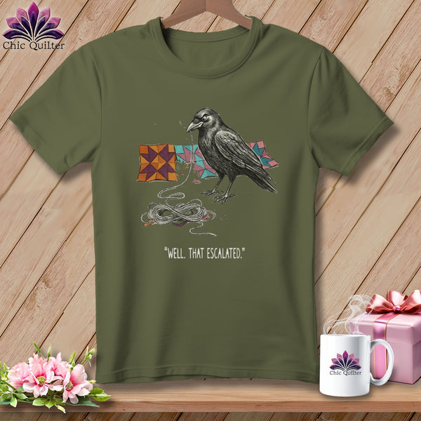 Olive t-shirt with a raven unraveling quilt squares and thread, reads "WELL, THAT ESCALATED."