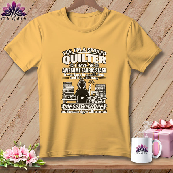 Golden yellow t-shirt featuring a quilting graphic and text that reads Yes Im a Spoiled Quilter.