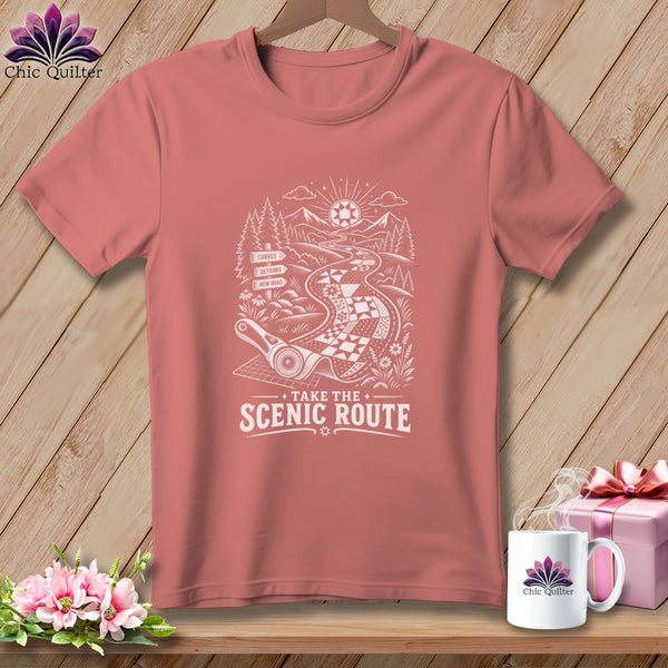 Salmon pink t-shirt with a white graphic of a quilt road with text "Take the Scenic Route".