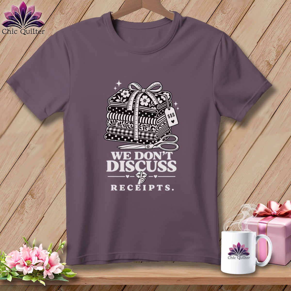 T-shirt with stacked fabric, scissors, and text "We Don't Discuss Receipts".