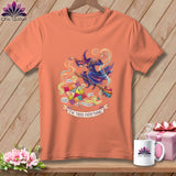 Orange t-shirt with a witch on a broomstick, quilt squares, and 