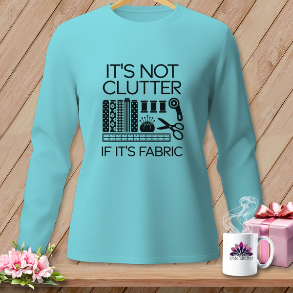 Teal long-sleeve shirt with "It's Not Clutter If It's Fabric" graphic.