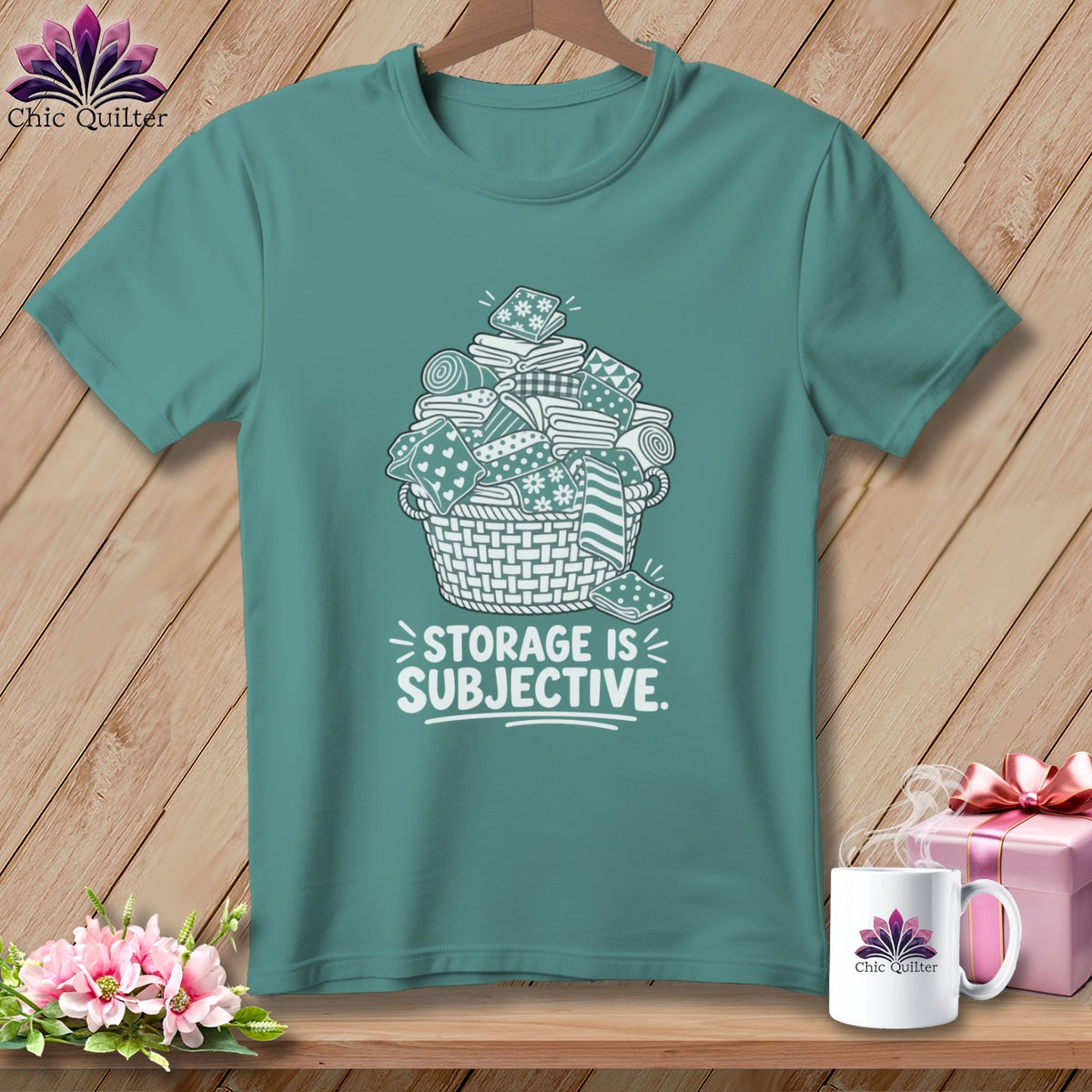 Teal t-shirt with basket of fabric scraps and "STORAGE IS SUBJECTIVE" text.