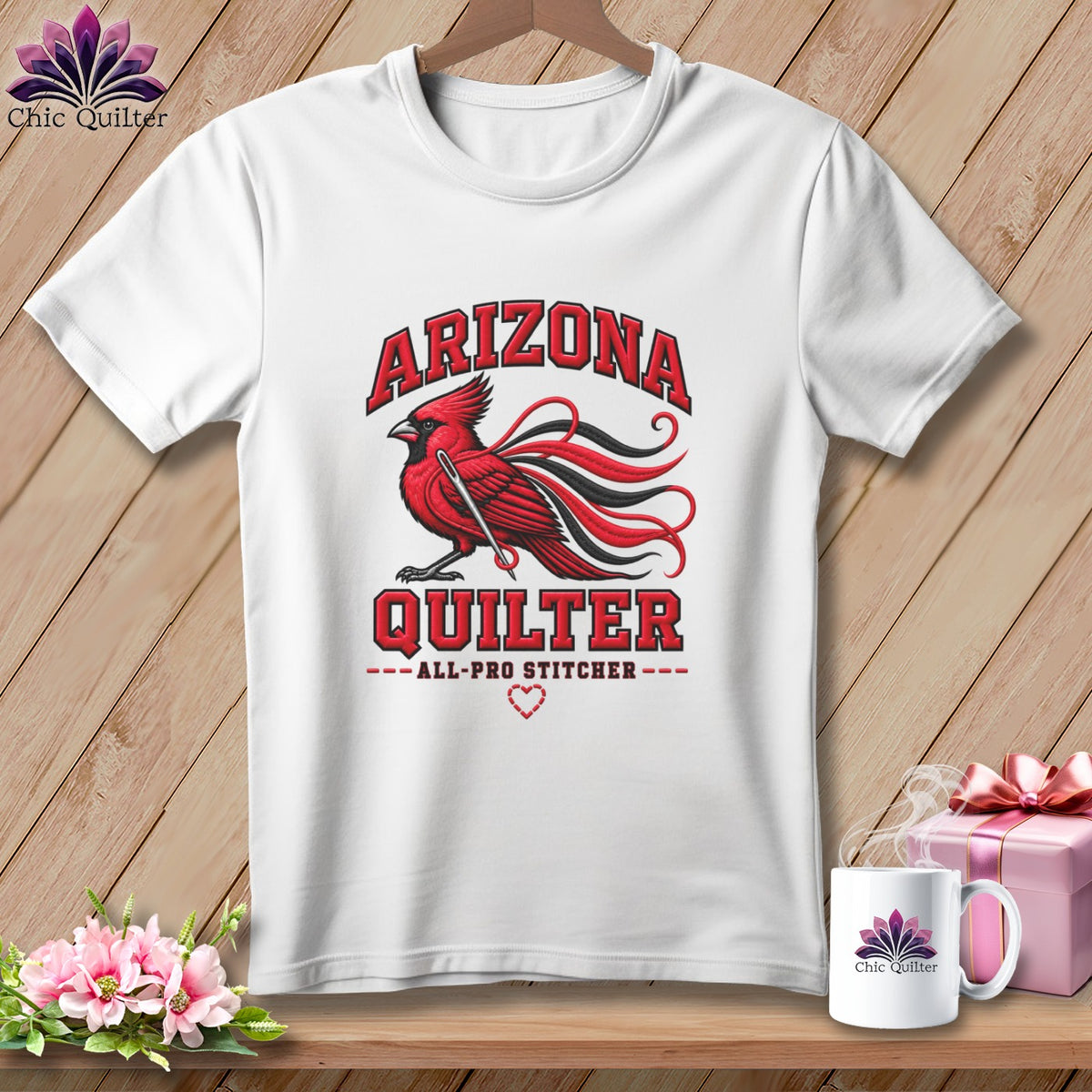 White t-shirt featuring a red cardinal graphic and the text Arizona Quilter on a wooden background.