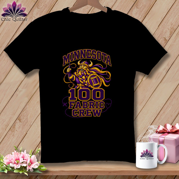 Black t-shirt featuring a cartoon viking graphic with the text Minnesota 100 Fabric Crew.