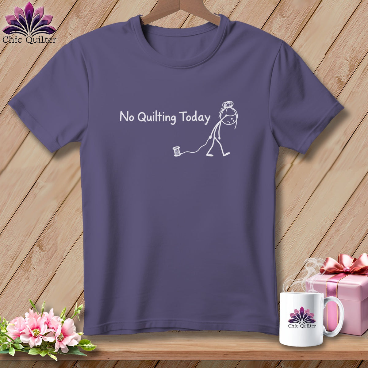 Purple t-shirt with "No Quilting Today" text and a stick figure pulling a spool.