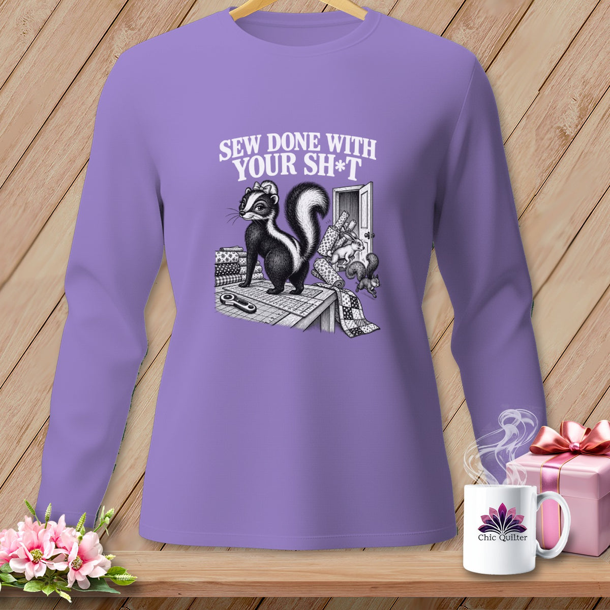 Skunk wearing a bow on a sewing table with text "SEW DONE WITH YOUR SH*T".
