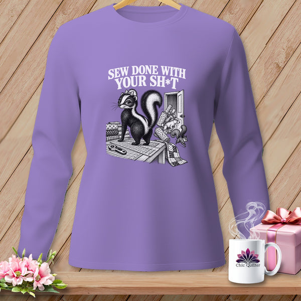 Skunk wearing a bow on a sewing table with text "SEW DONE WITH YOUR SH*T".