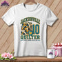 A white t-shirt features a Jacksonville Quilter graphic with a folded quilt stack, measuring tape, and coffee mug.