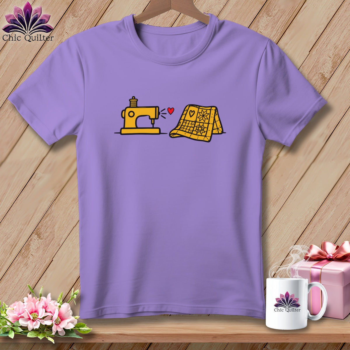 A purple t-shirt printed with a graphic of a yellow sewing machine and a quilt.