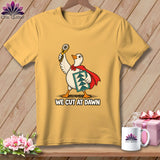 Gold crewneck t-shirt featuring a superhero duck holding a rotary cutter and quilt block, with the text WE CUT AT DAWN.