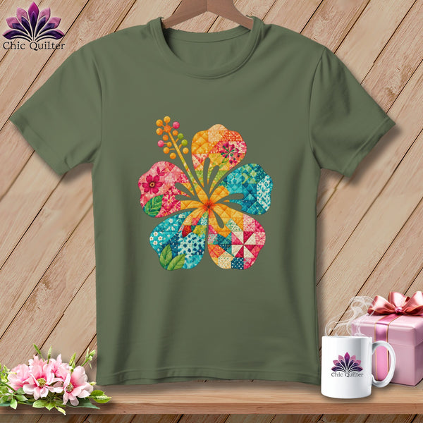 Olive green crewneck t-shirt featuring a colorful, patchwork hibiscus flower graphic on the chest.