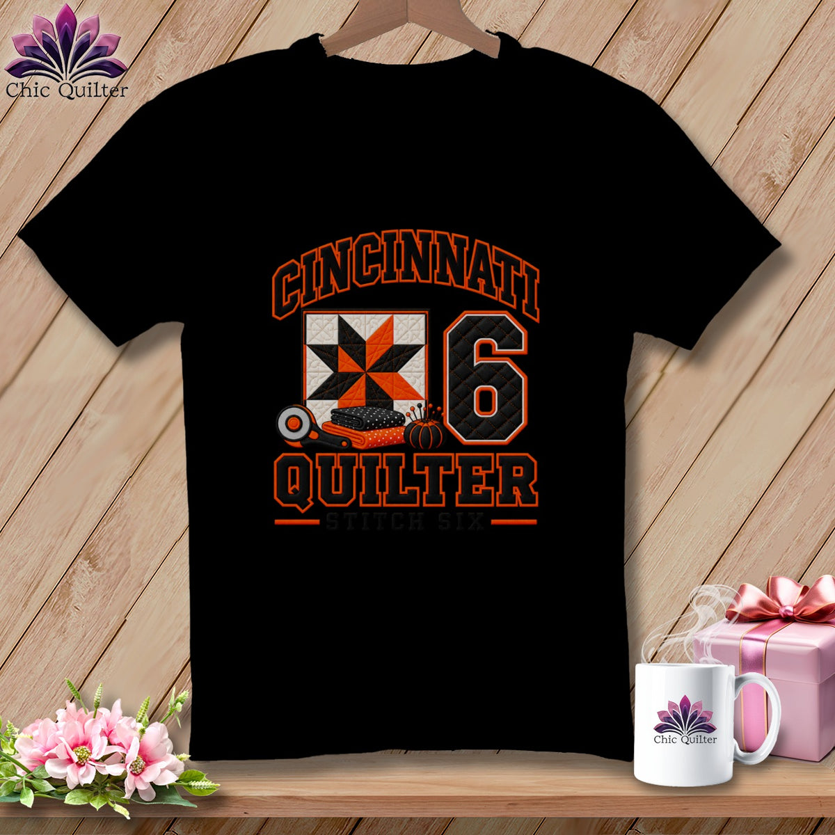 Black t-shirt featuring a Cincinnati Quilter graphic with a quilt block and the number six.