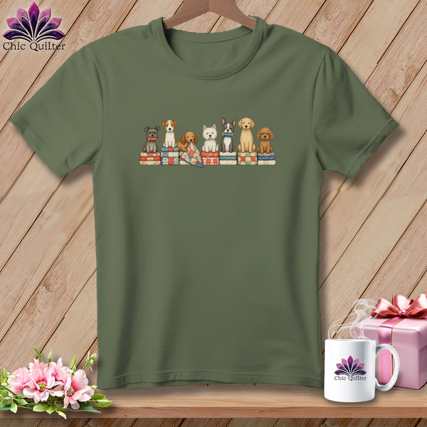 Olive green t-shirt with a graphic of seven cute dogs sitting on folded quilts.