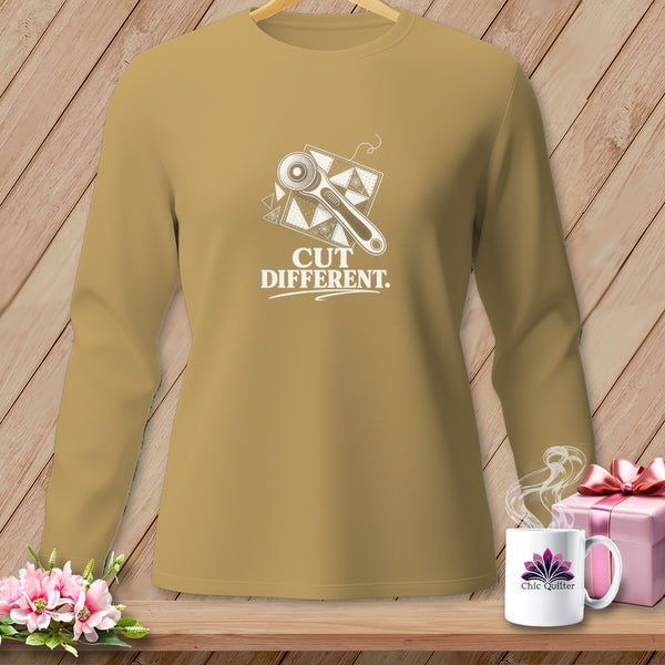 Long-sleeve shirt with rotary cutter and quilt block graphic. Text reads "CUT DIFFERENT.".