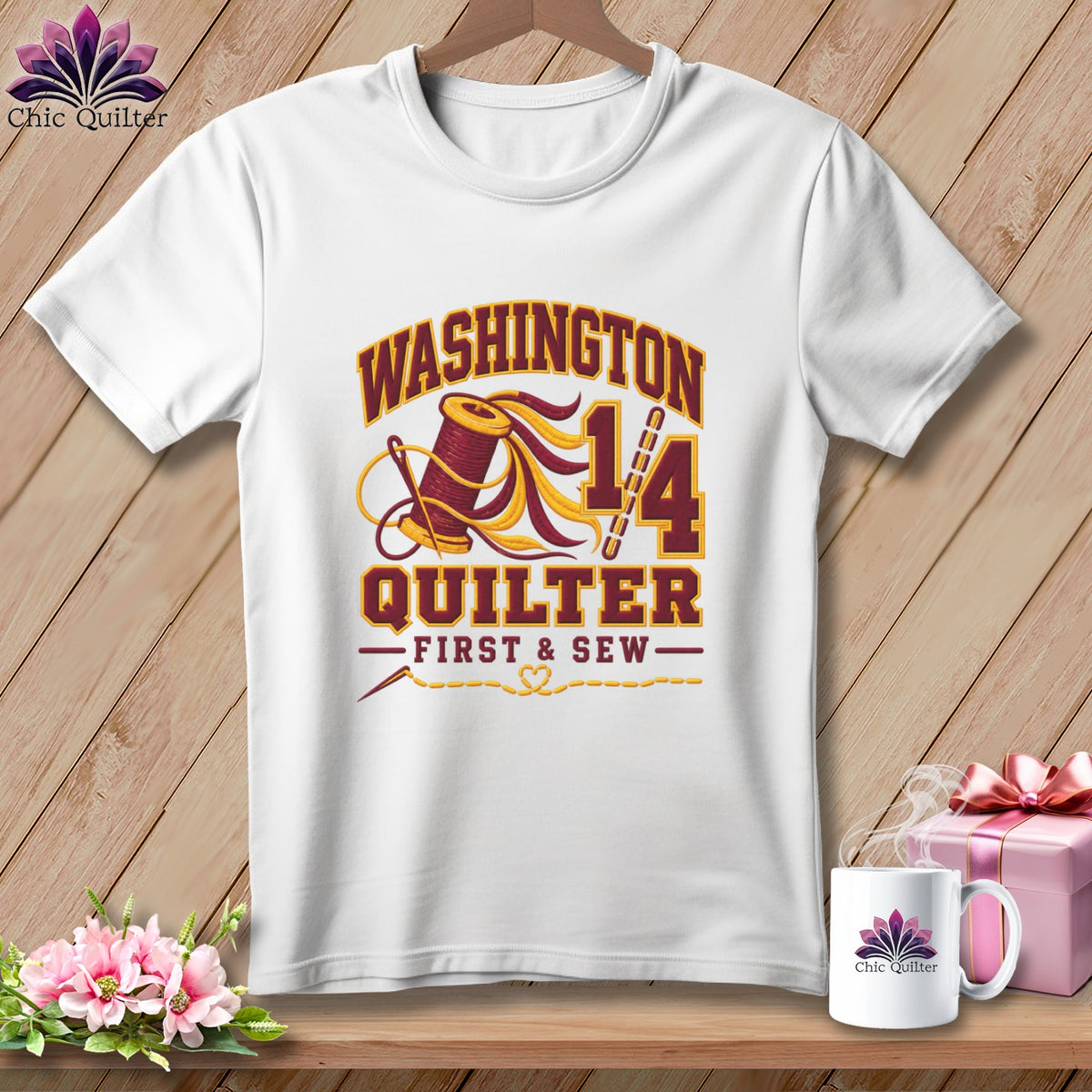 A white t-shirt featuring a Washington Quilter design with a spool of thread, needle, and text.