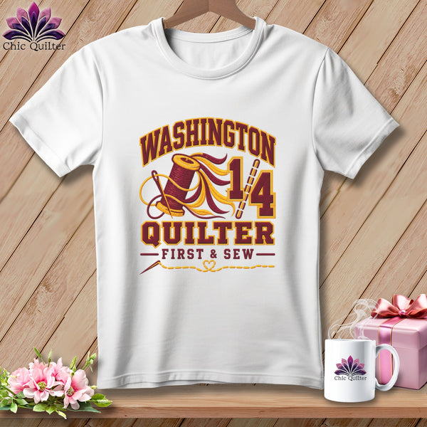 A white t-shirt featuring a Washington Quilter design with a spool of thread, needle, and text.