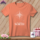 Coral t-shirt with white compass graphic and text 