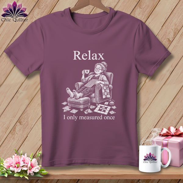 T-shirt with "Relax" and woman with quilt squares, mug, and pin cushion.