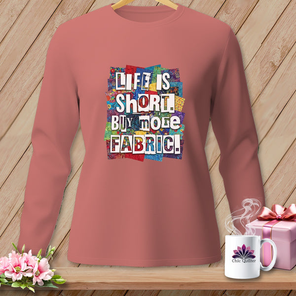 Long-sleeved salmon shirt with "Life Is Short. Buy More Fabric!" graphic.