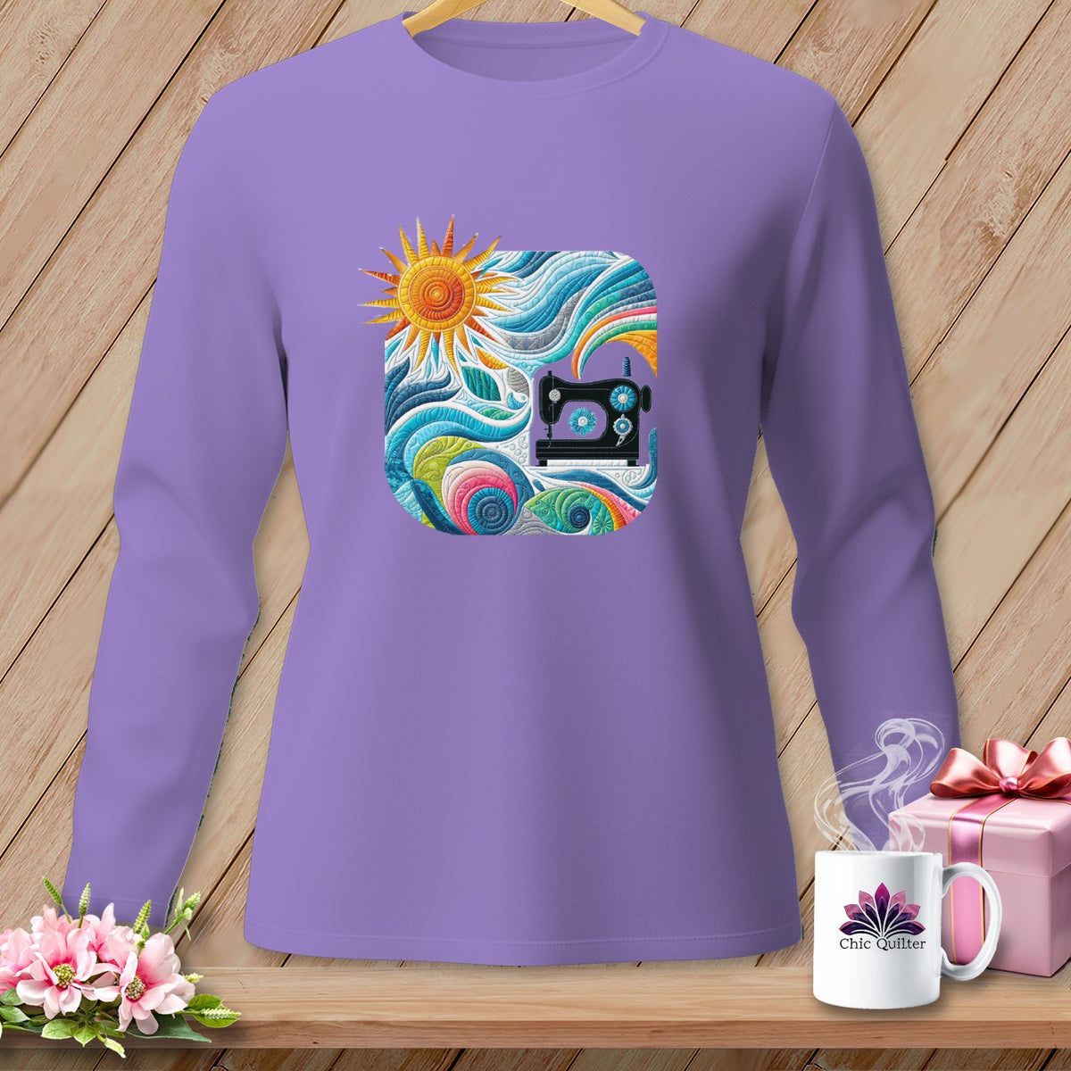 Purple long-sleeve shirt with a colorful square graphic of a sewing machine and sun.