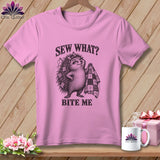 Pink t-shirt with a graphic of a hedgehog holding a quilt and the text Sew What? Bite Me.