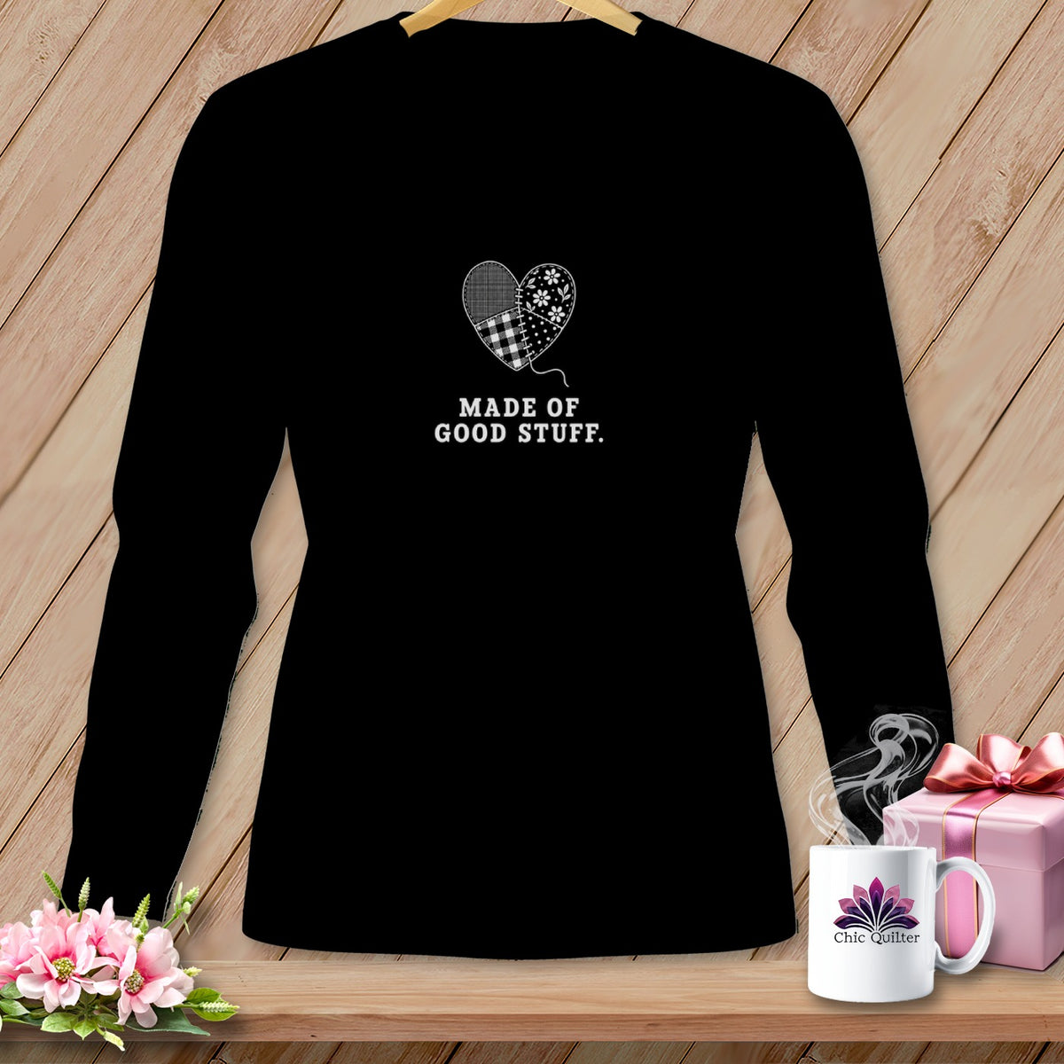 Black long-sleeve shirt with a patched heart graphic and "Made of Good Stuff" text.
