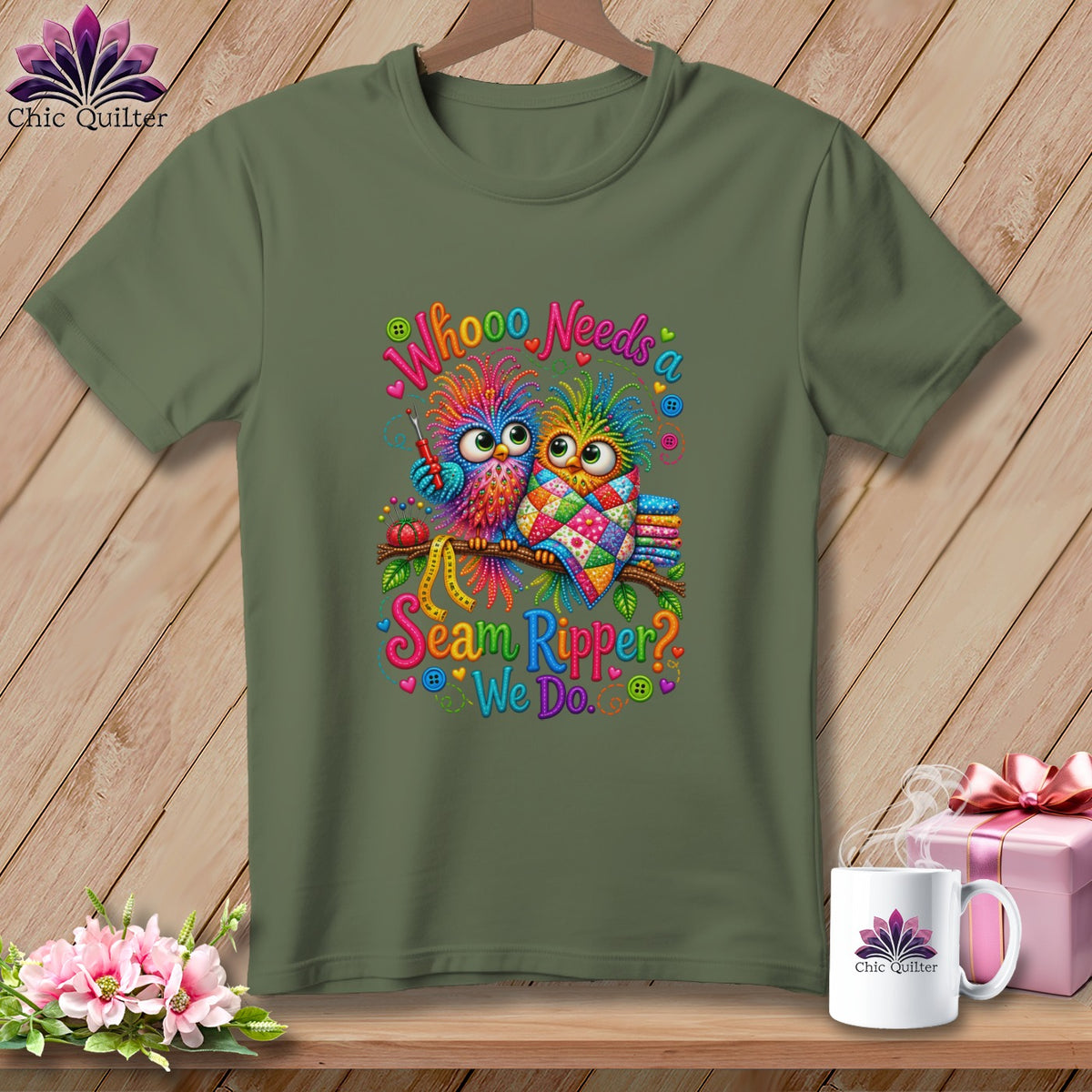 Olive green t-shirt with a colorful graphic of two owls and the text Whoooo Needs a Seam Ripper? We Do.