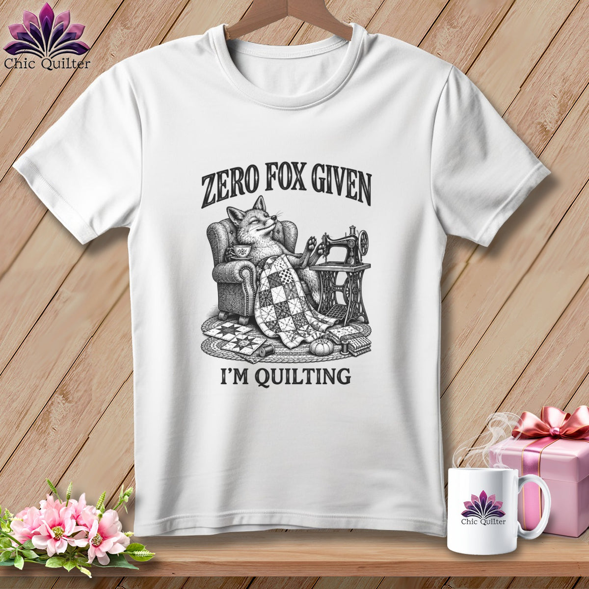 White t-shirt with a fox relaxing with a quilt and sewing machine, reads "Zero Fox Given, I'm Quilting."