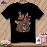 Black t-shirt with a whimsical house graphic made of books and fabric scraps.