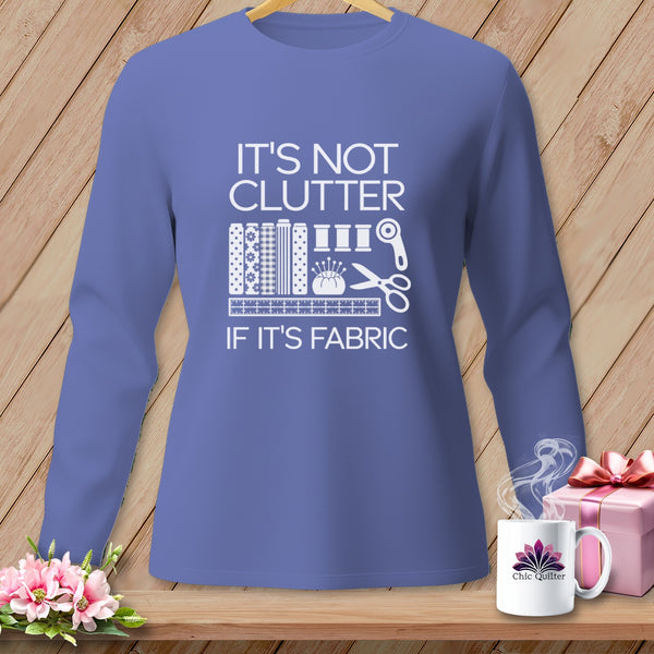 Long-sleeved purple shirt with "It's not clutter if it's fabric" and sewing icons.