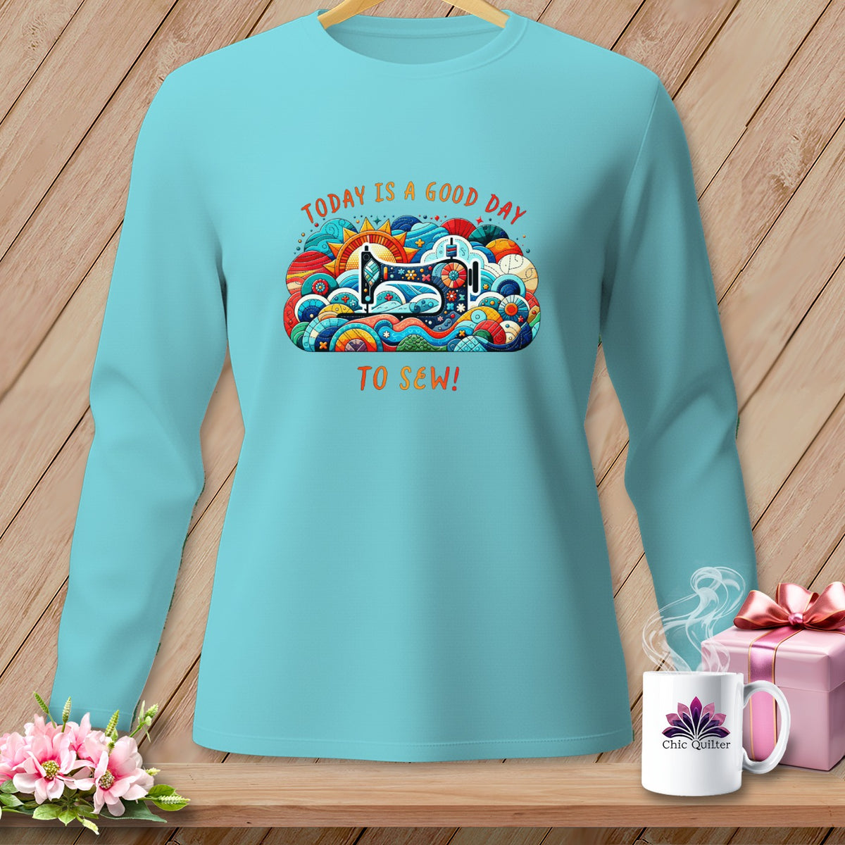 Turquoise long-sleeve shirt with "Today is a good day to sew!" graphic.