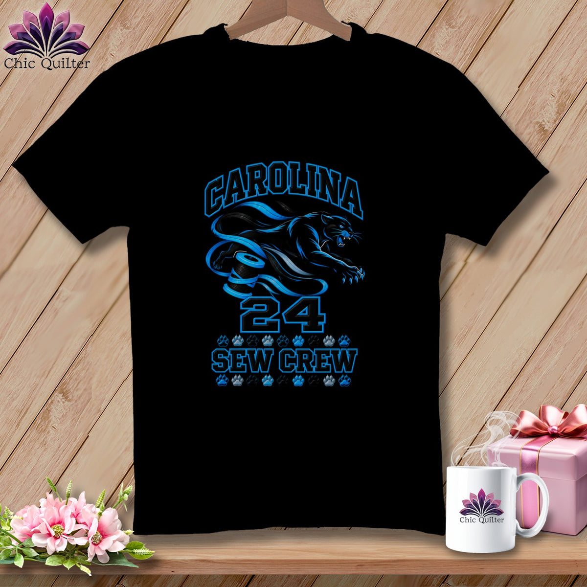 Black t-shirt featuring blue text reading CAROLINA 24 SEW CREW with a panther graphic and paw prints.