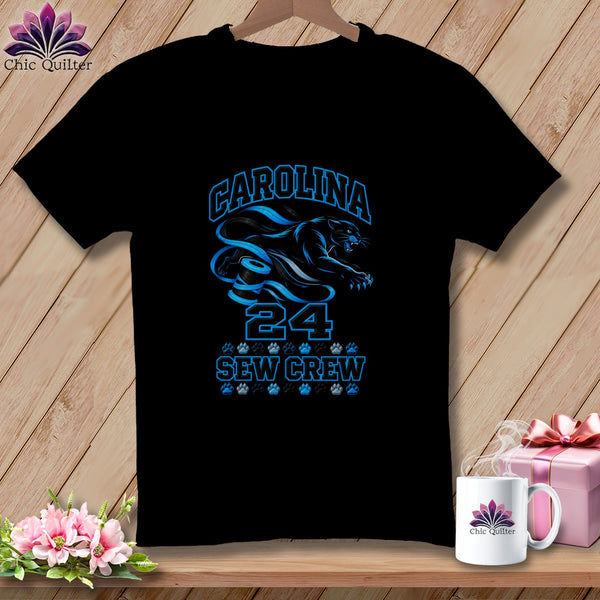 Black t-shirt featuring blue text reading CAROLINA 24 SEW CREW with a panther graphic and paw prints.