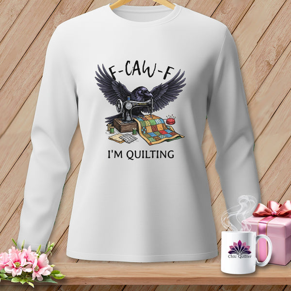 White long-sleeve shirt with crow sewing a quilt, "F-CAW-F" and "I'M QUILTING" text.